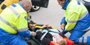 Woman in head brace on stretcher