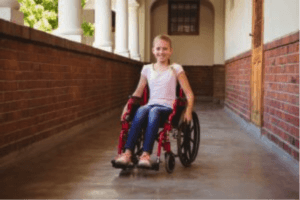 young girl in wheelchair in hall